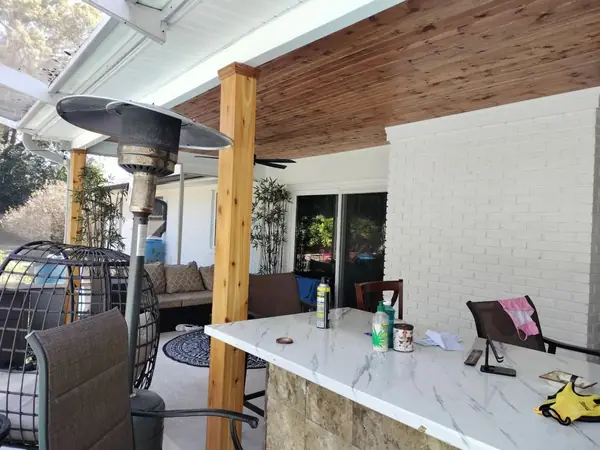 Outdoor kitchen with a cedar plank ceiling