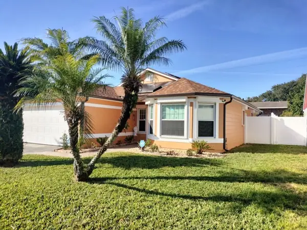 Coral stucco home after an exterior repaint
