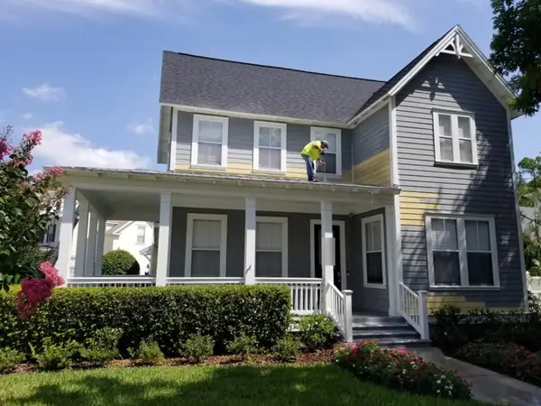 Repainting a gray two-story home with a front porch