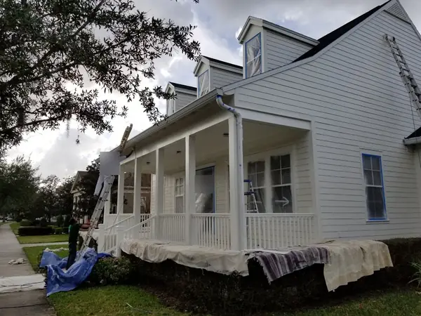 Painting the trim and columns on a wraparound porch