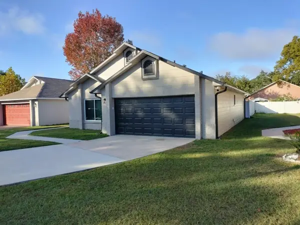 Ranch home repainted with a charcoal garage door