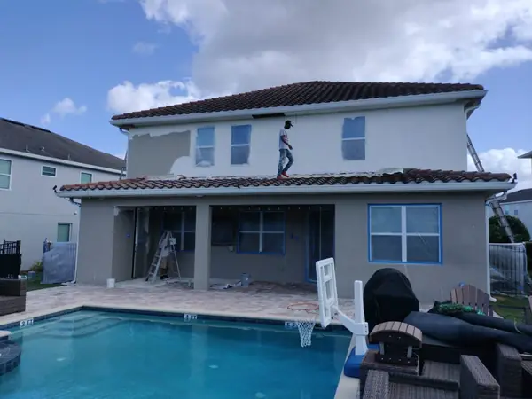 Repainting a stucco pool home